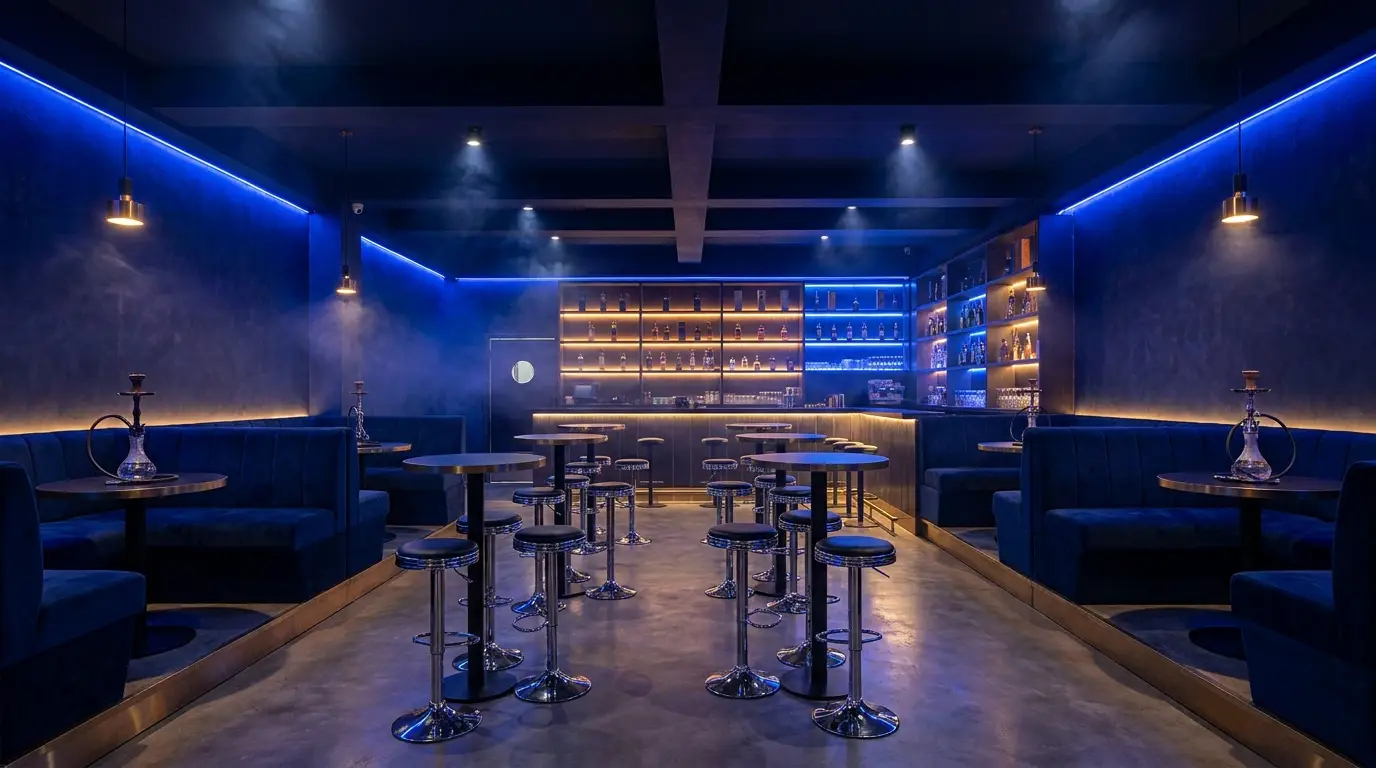 Exhale Cafe's dark lounge interior lit with royal-blue neon, navy velvet booths and chrome high-top tables